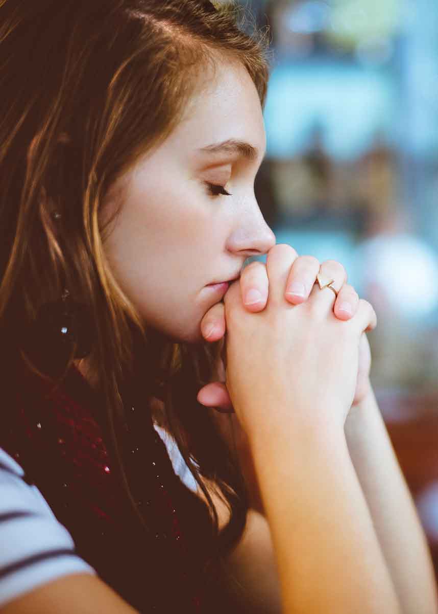 Girl praying in restaurant